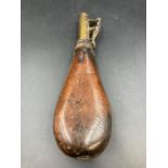 A 19th century spring loaded leather powder flask