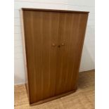 A teak Mid Century wardrobe, hanging rail to left and shelves to right (H150cm W95cm D59cm)