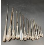 A selection of fourteen hallmarked silver handled button hooks, various makers, hallmarks and