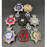 A selection of United Kingdom Police badges and helmet insignia.