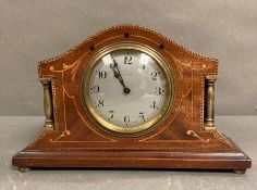 A mahogany inlaid eight day mantel clock