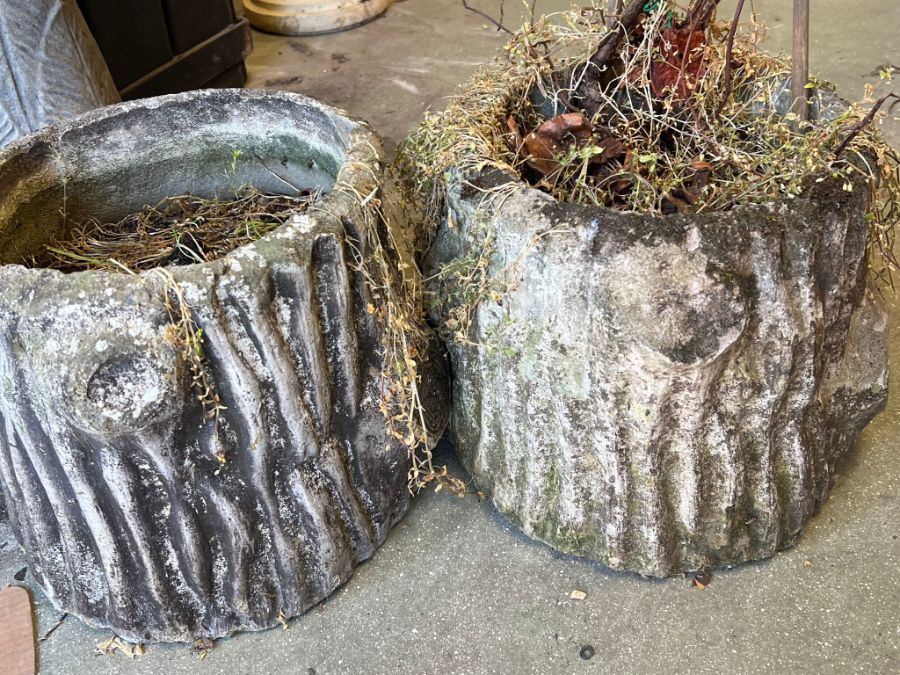 Three garden pots in the form of tree trunks