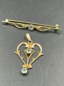 Two 9ct gold jewellery items a brooch and a pendant.