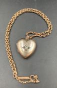 A 9ct gold chain (Approximate weight 8.4g) and a heart shaped pendant marked real gold (