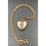 A 9ct gold chain (Approximate weight 8.4g) and a heart shaped pendant marked real gold (