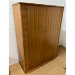 A teak Mid Century wardrobe with mirror to the back of the doors