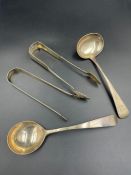 Two hallmarked silver sugar tongs and two hallmarked silver sauce ladles. (Approximate Total