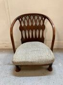 An Arts and Crafts nursing chair with grey upholstered cushion