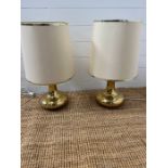 A pair of gilt Mid Century lamps and one other