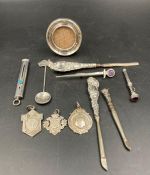 A selection of silver curios to include pencil, picture frame, medals etc.