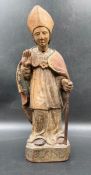 A wooden carved statue of Saint Blaise the bishop of Sebask, possibly 14th Century