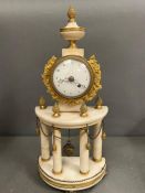 A white marble and brass shelf clock supported by marble pillars and brass accents