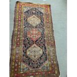 A Persian rug 196cm x 103cm