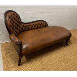 A faux leather chaise long with button back (H85cm W165cm D63cm SH34cm)