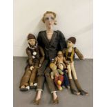 A collection of vintage dolls and puppets