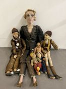 A collection of vintage dolls and puppets