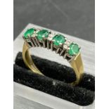 A Four stone emerald and diamond ring, marked for 750 yellow gold (Approximate Total weight 3.5g)