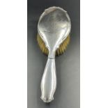 A hallmarked silver backed hairbrush, Birmingham 1919 by E S Barnsley & Co