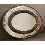 A distressed oval hall mirror with a faceted glass border 77x60