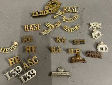 A selection of brass military badges