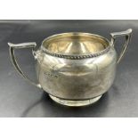 A Hallmarked silver sugar bowl with two handles, approximate total weight 140g Birmingham 1925.