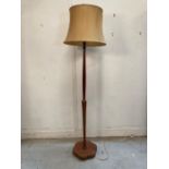 A mahogany standard lamp on turned central column