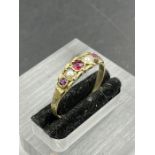 A 9ct gold ring with seed pearl and garnets (Approximate Total Weight 1.3g) Size R