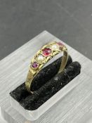 A 9ct gold ring with seed pearl and garnets (Approximate Total Weight 1.3g) Size R