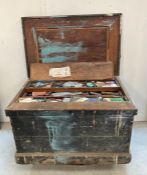 A large vintage wooden steal banded tool box with cast iron handles containing and extensive