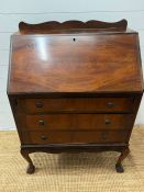 A mahogany bureau, the fall enclosing interior fitted above three long drawers (H100cm W75cm D43cm)