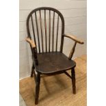 A spindle backed farmhouse arm chair