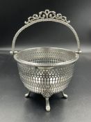 A Victorian hallmarked silver pierced basket on four feet with handle. Birmingham 1857 by Henry