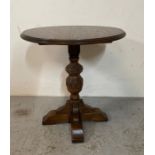 An oak side table on carved central support (H59cm Dia56cm)