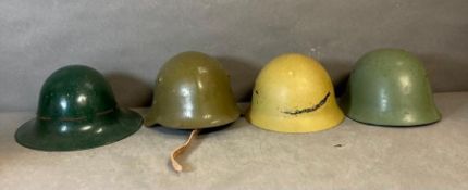 A selection of four military helmets