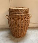 A wicker two handled laundry basket