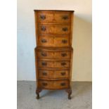 A walnut seven drawer serpentine fronted chest on chest with drop handles (H115cm W46cm D41cm)