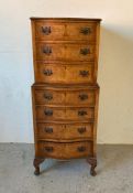 A walnut seven drawer serpentine fronted chest on chest with drop handles (H115cm W46cm D41cm)