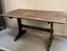 An oak refectory dining table on twin acanthus carved scroll end supports with cross stretcher )