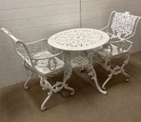 A white painted wrought iron bistro set