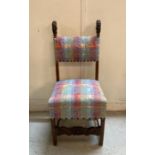 A mahogany carved African threaded upholstered chair