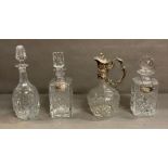 A selection of four cut glass decanters one with silver decanter tag hallmarked for birmingham