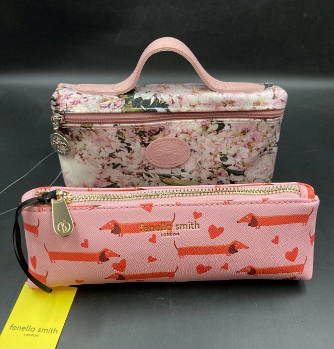 Two ladies wash bags a Longchamps with floral design and one by Fenella Smith with dachshunds