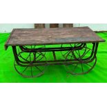A vintage reclaimed cart, wooden planked top on metal frame and spindle wheels (H58cm Q127cm D69cm)