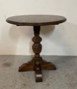 An oak side table on carved central support (H59cm Dia56cm)