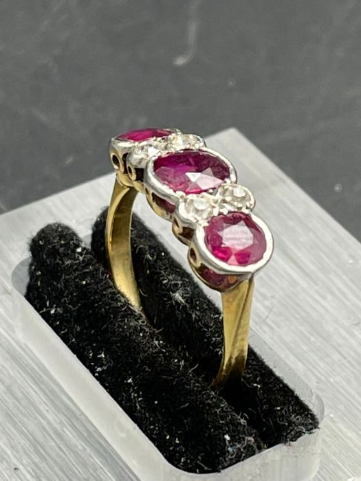 An Antique three stone ruby ring with four small diamonds. Size K - Image 4 of 4