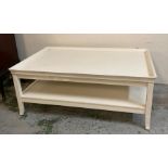 A large white painted coffee table with shelf under
