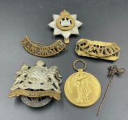 A small selection of Military insignia and a WWI Ware Medal for 54147 PTE W C WEEKS MANCH R