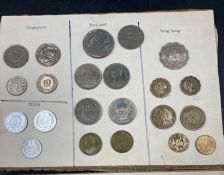 A selection of International coins mounted on board, including Australia, Austria, Belgium,