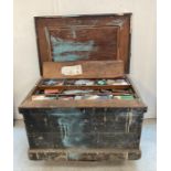 A large vintage wooden steal banded tool box with cast iron handles containing and extensive