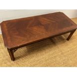 A long low coffee table with carved corner supports (132cm x 58cm)